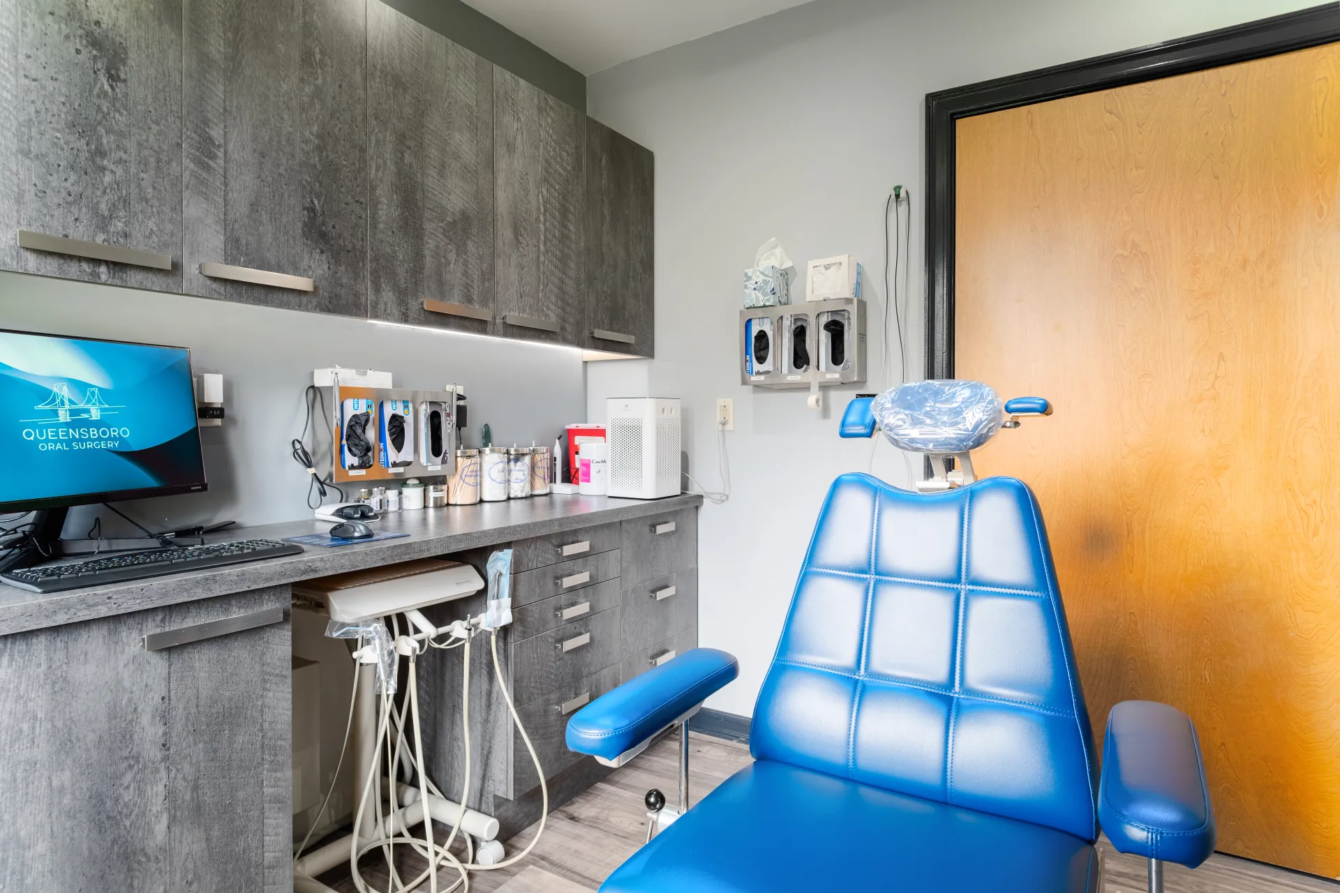 Fully equipped operatory with digital monitors at Queensboro Oral Surgery